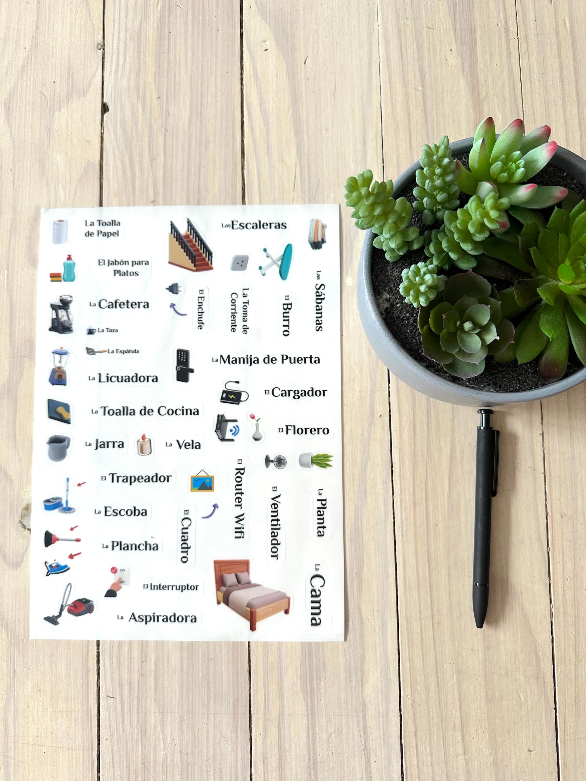 Page 1 of Lingo Stickers next to a pen for scale. pages are 8.5 x 11.